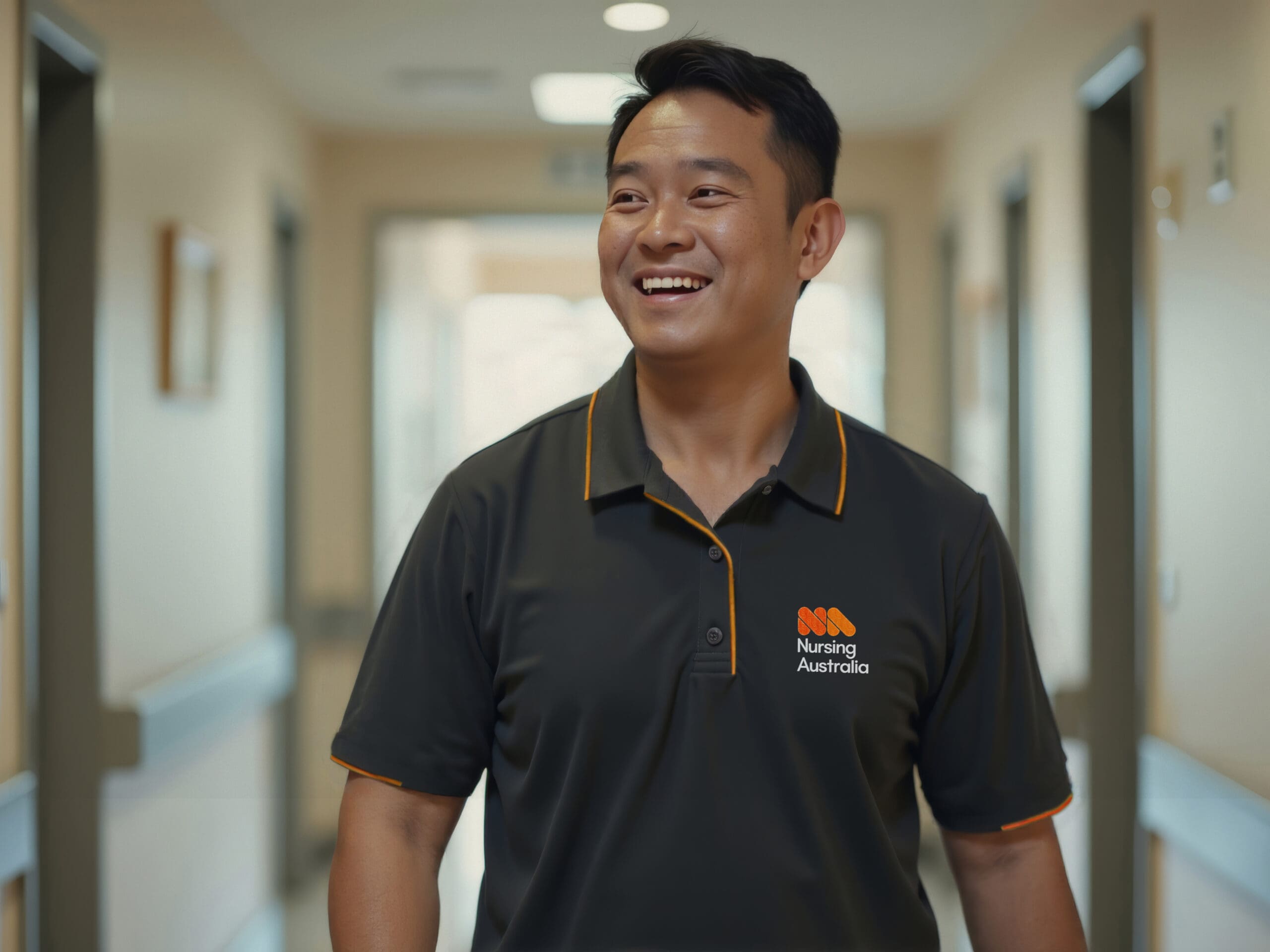 Smiling man in a black and orange 